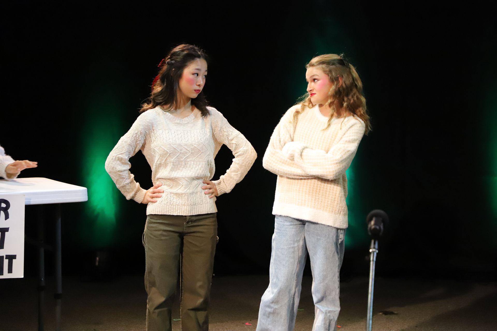 Two women are standing next to each other on a stage.