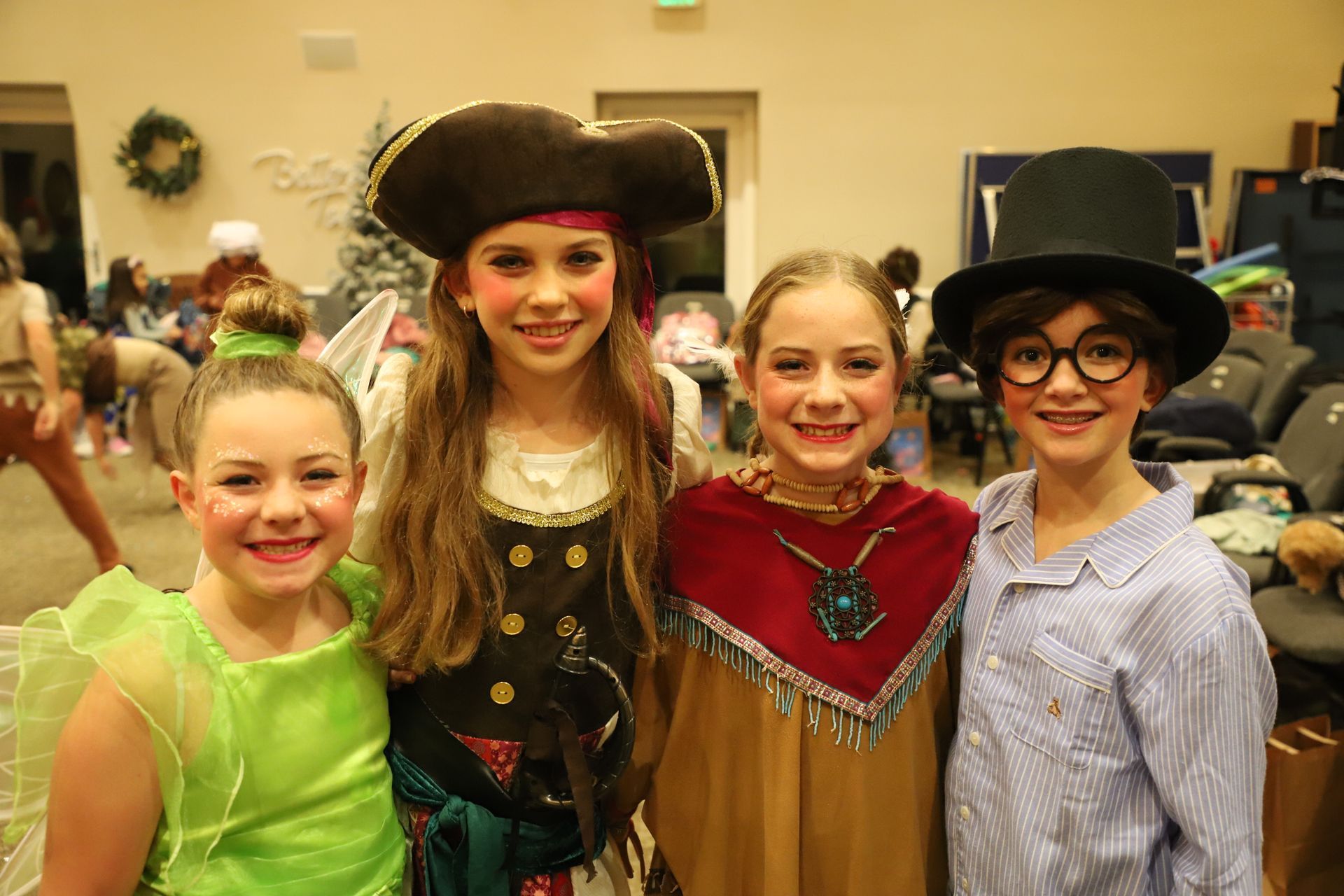 A group of young girls dressed in costumes are posing for a picture.