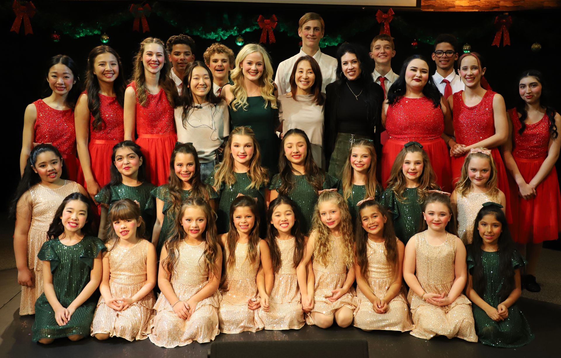 A group of young people are posing for a picture on a stage.