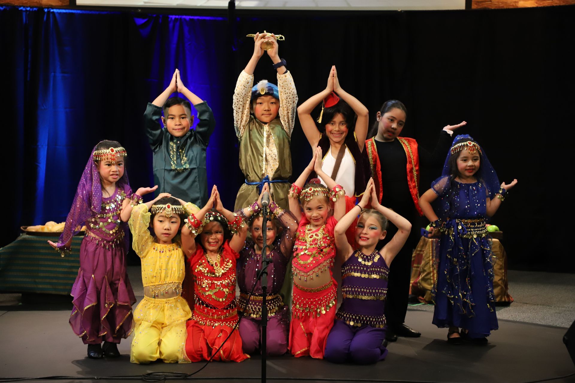 A group of children in costume are posing for a picture