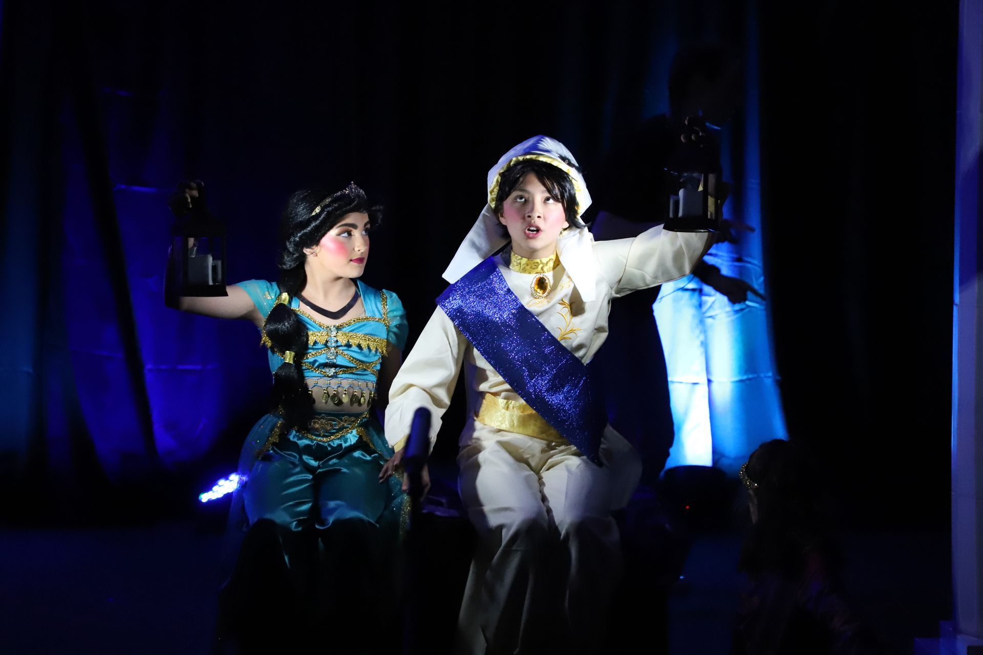 A man and a woman are standing next to each other on a stage.