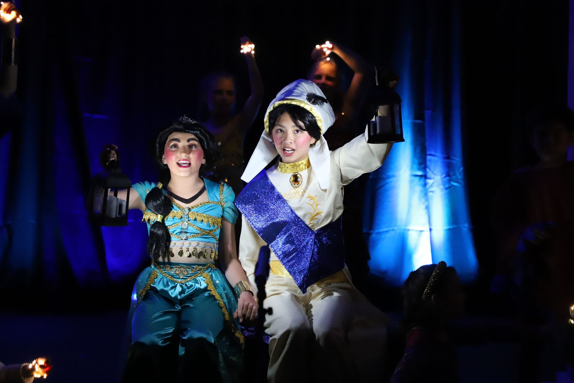 A couple of people in costumes are standing next to each other in a dark room.