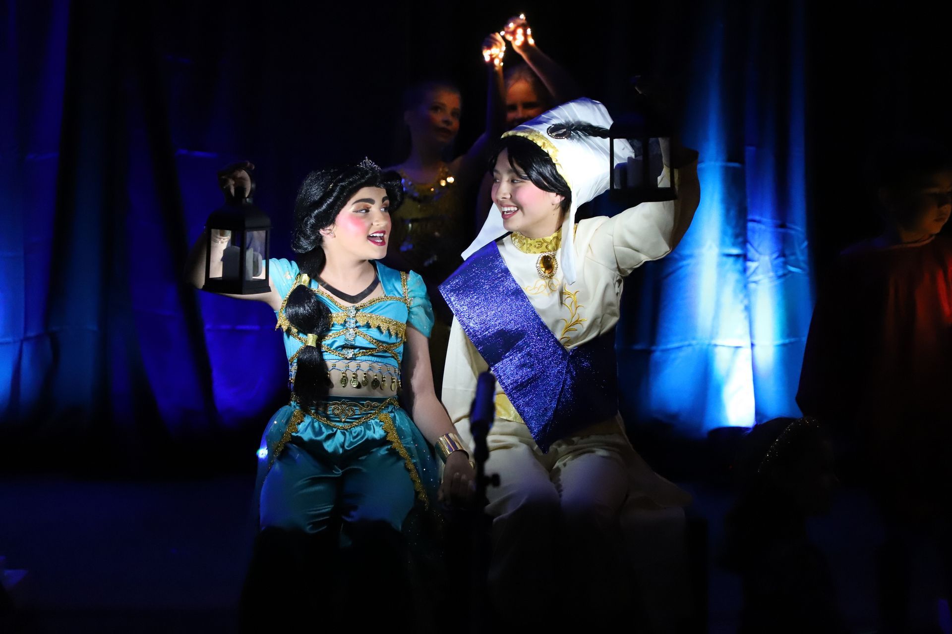 A man and a woman are standing next to each other on a stage.