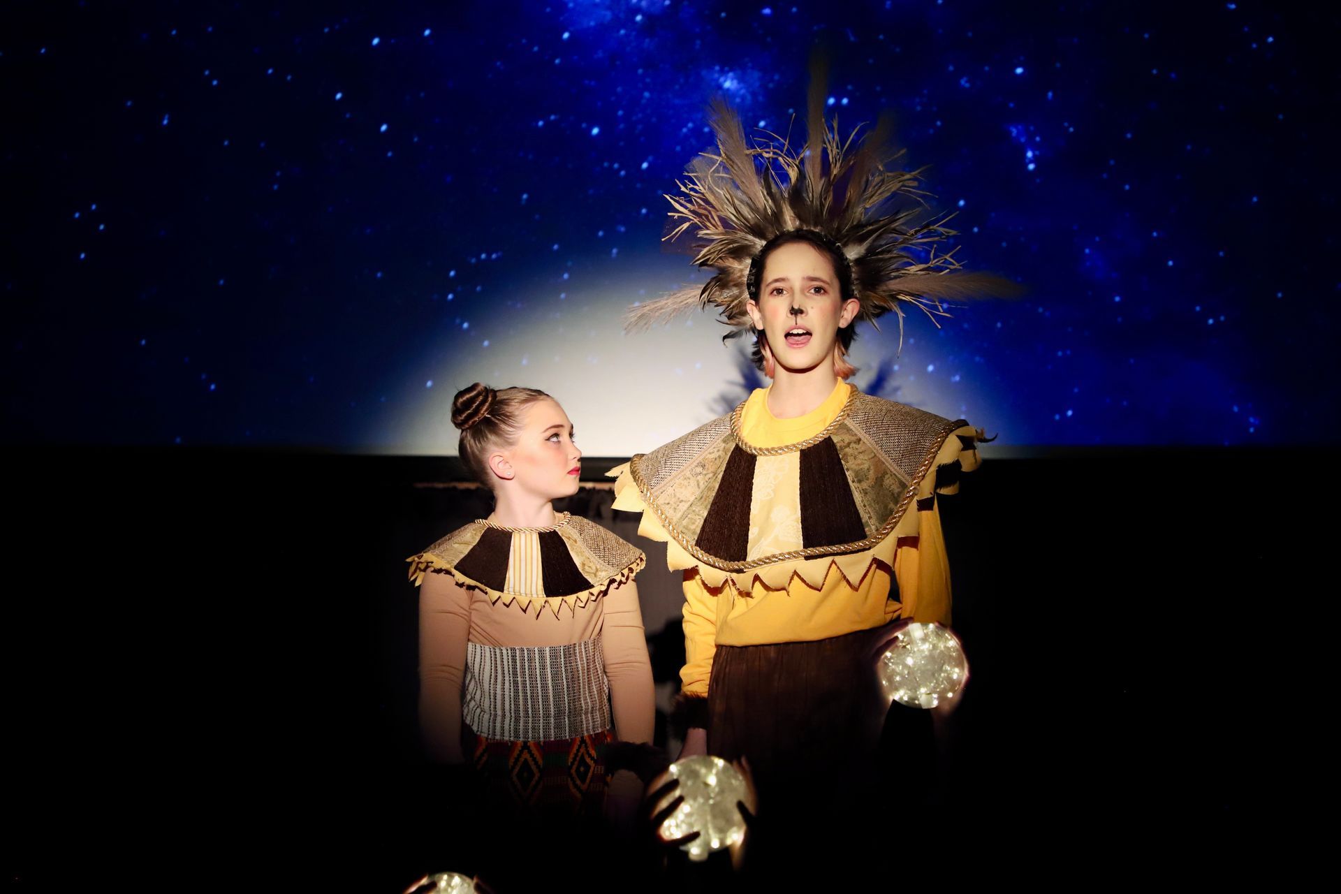 A man and a woman are standing next to each other on a stage.