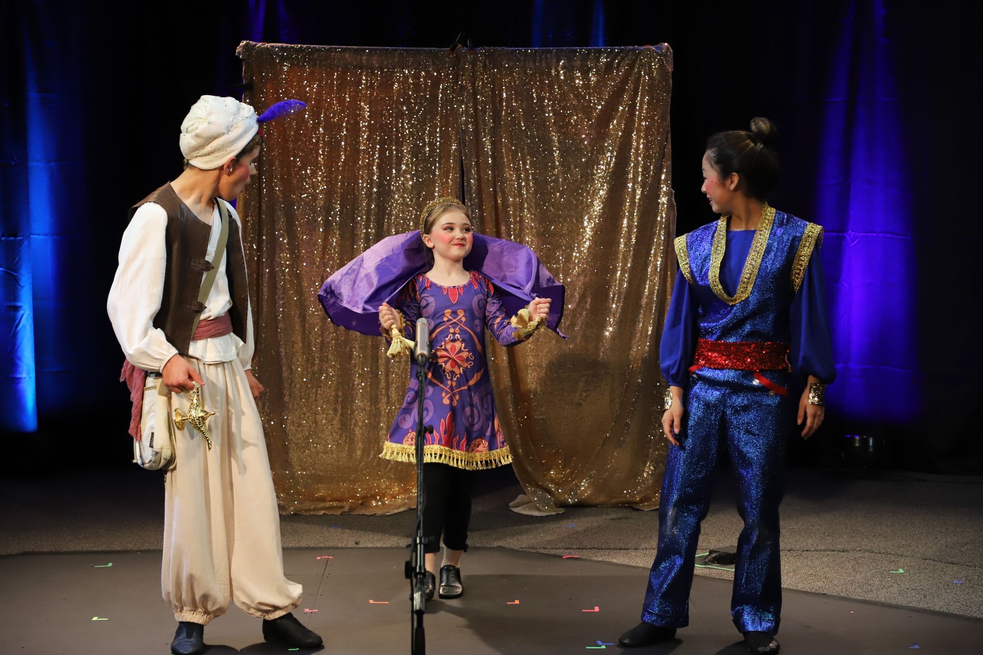 A group of people in costume are standing on a stage.