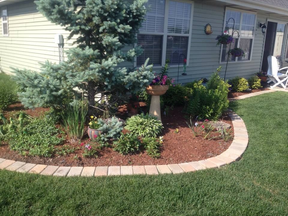 A wooden fence is sitting on top of a lush green field.