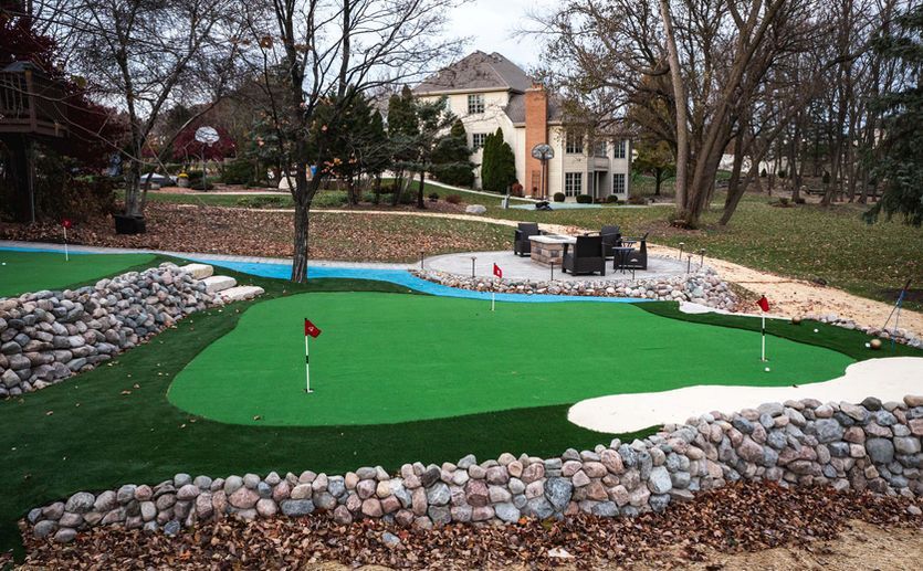 A wooden fence is sitting in the middle of a grassy field.