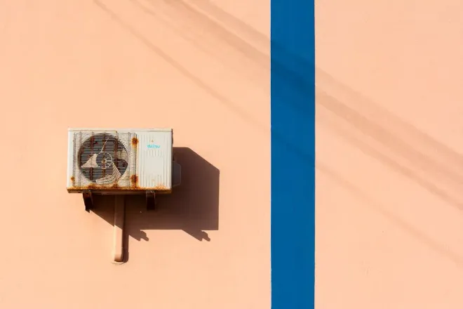 A white air conditioner is mounted on a wall.