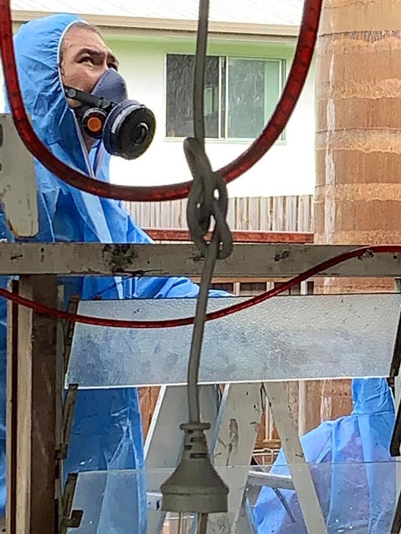 Wooden frame against a concrete wall with water stains and small black specks; a close-up, indoor shot.