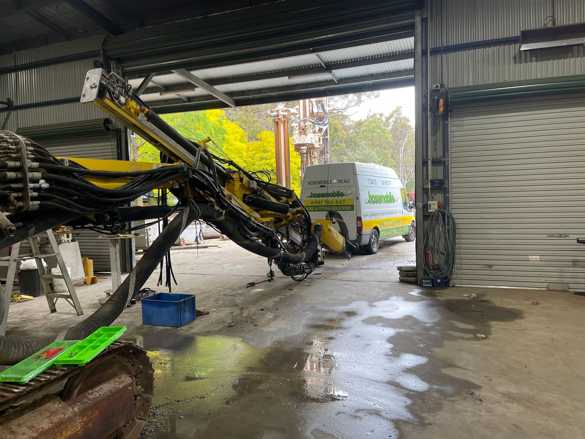 A machine is sitting in a garage next to a van. — Hosemobile In Kariong, NSW