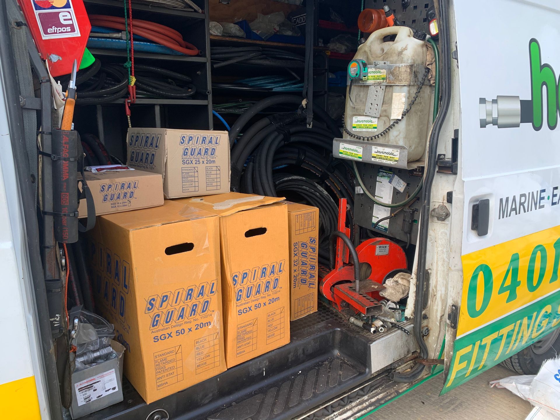 The back of a van with boxes of spiral brass on it — Hosemobile In Kariong, NSW