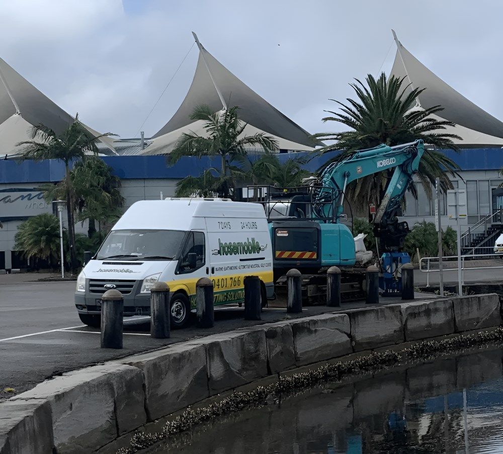 A Van And Excavator Are Parked Next To A Body Of Water — Hosemobile In Kariong, NSW