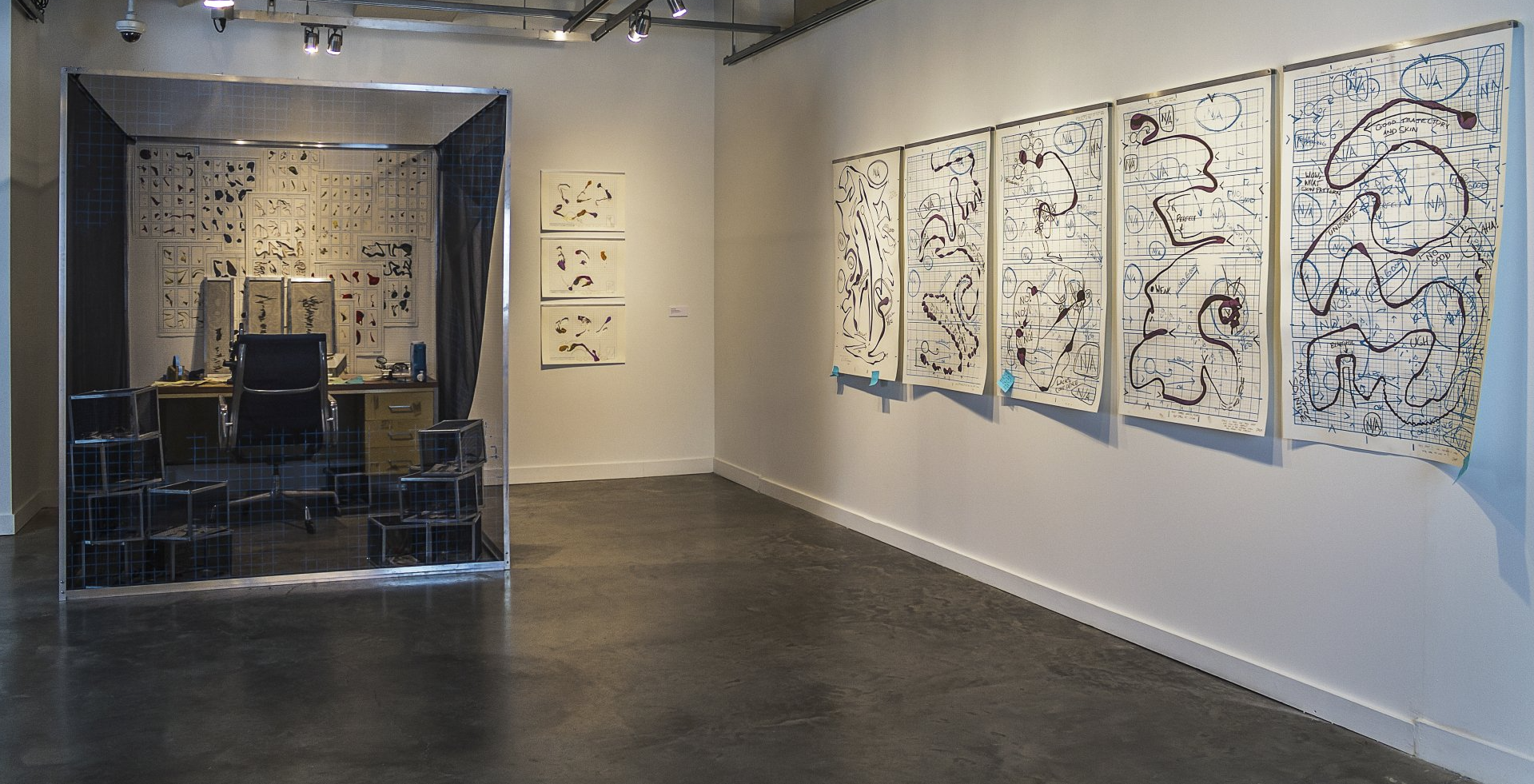 An image from a Dr. Armbruster installation, showing a vignette of Dr. Armbruster's office alongside multiple works on paper.
