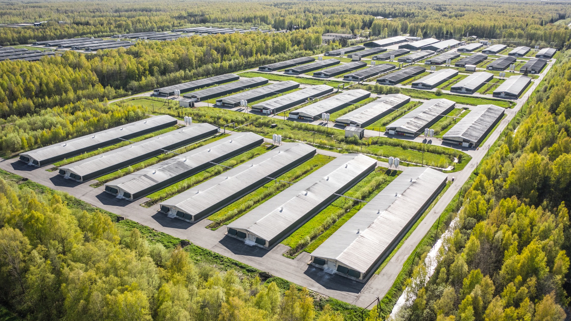An aerial view of a large industrial area surrounded by trees.