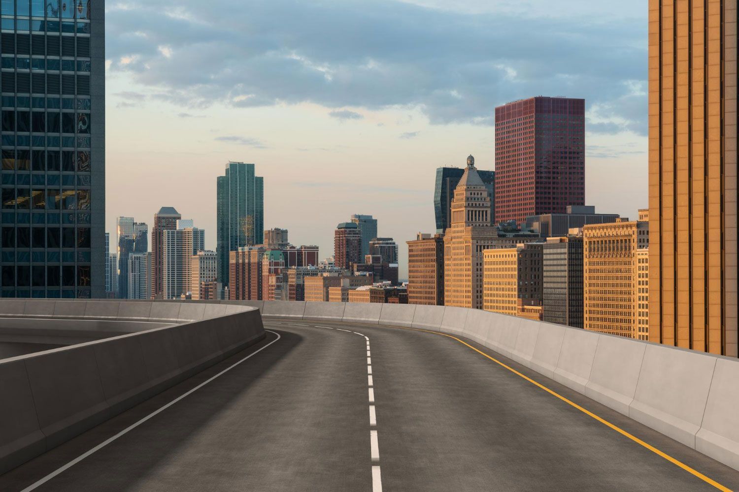 An empty highway with a city skyline in the background