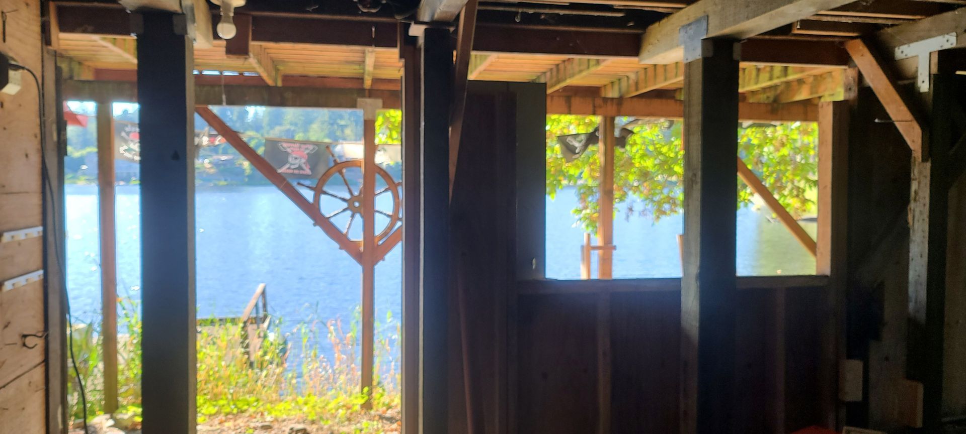 A room with a view of a lake through a window.