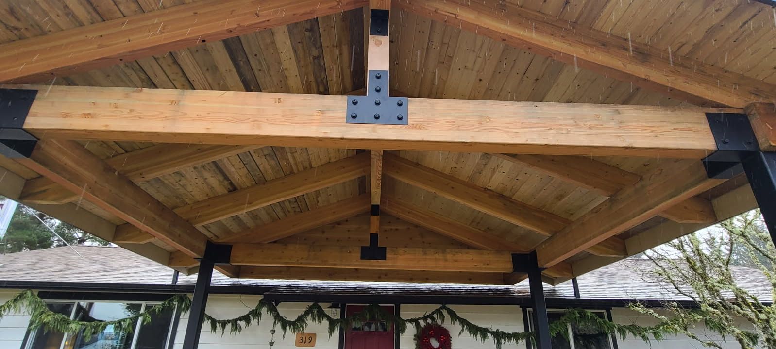 A wooden structure is sitting on top of a house.