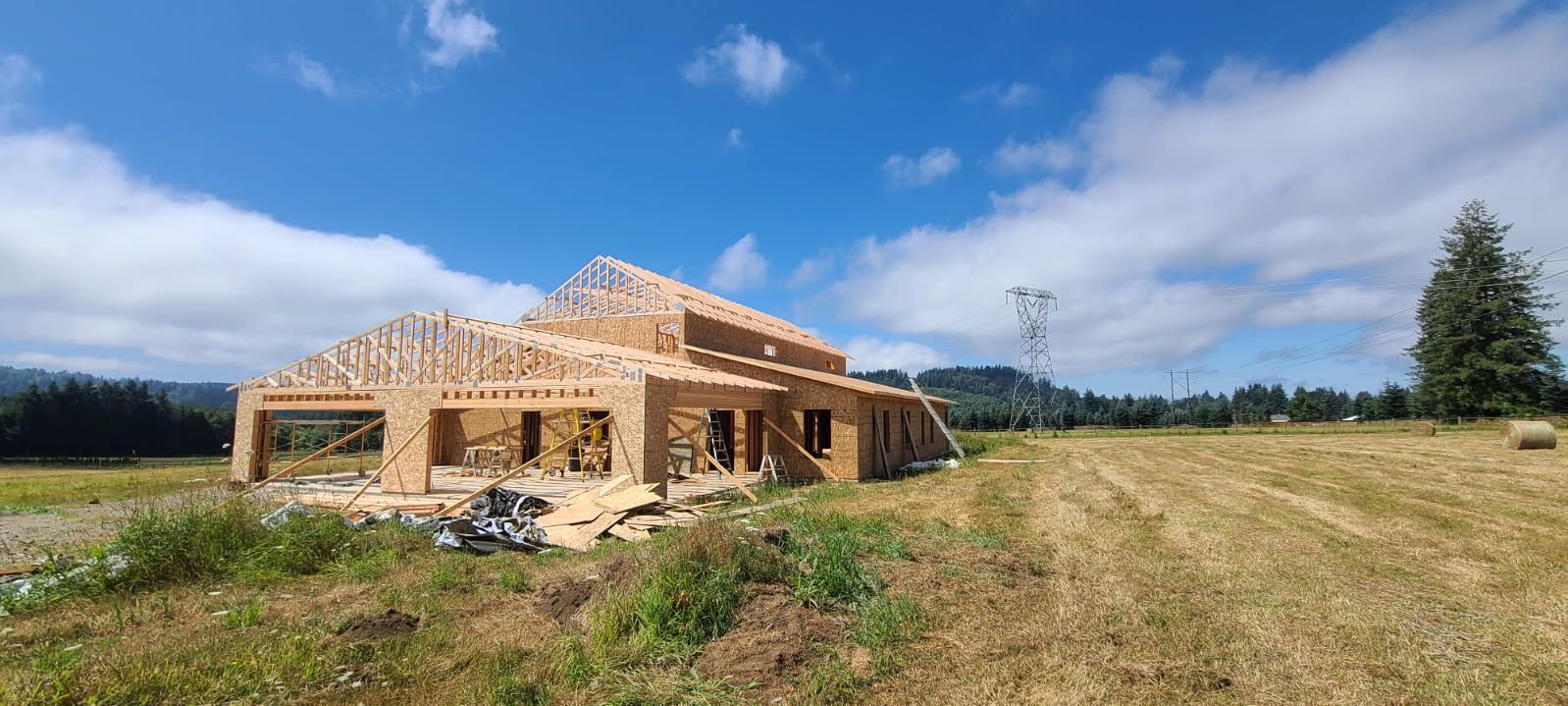 A house is being built in the middle of a field.