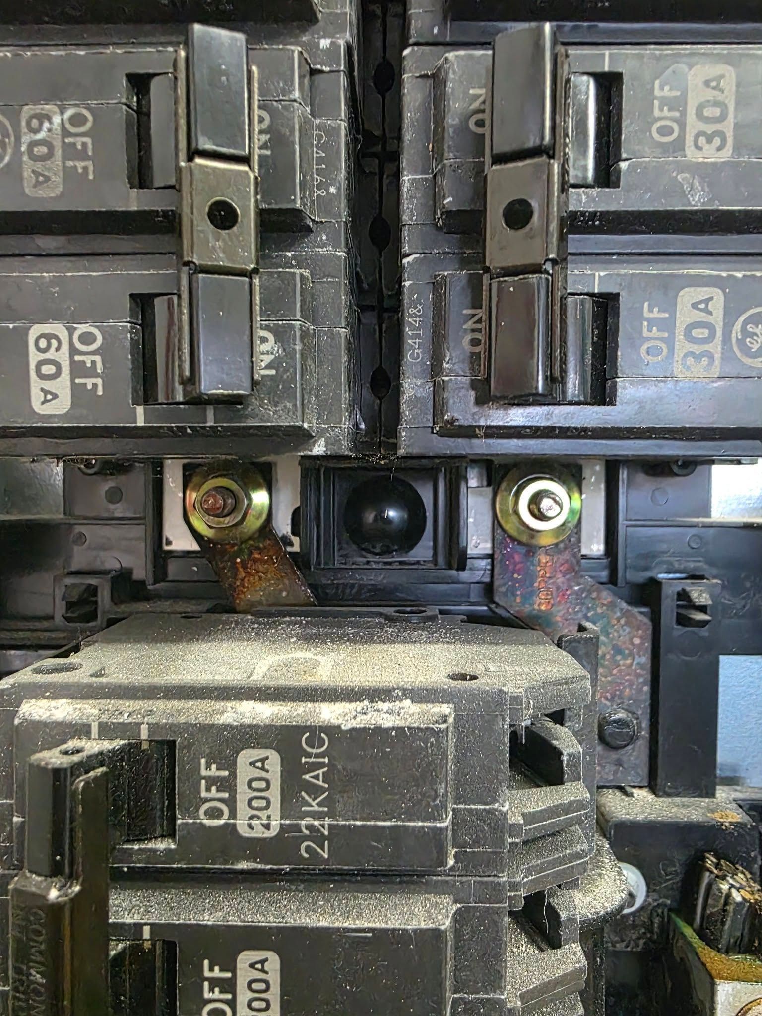 Close-up of a residential electrical panel with circuit breakers of varying amperages.