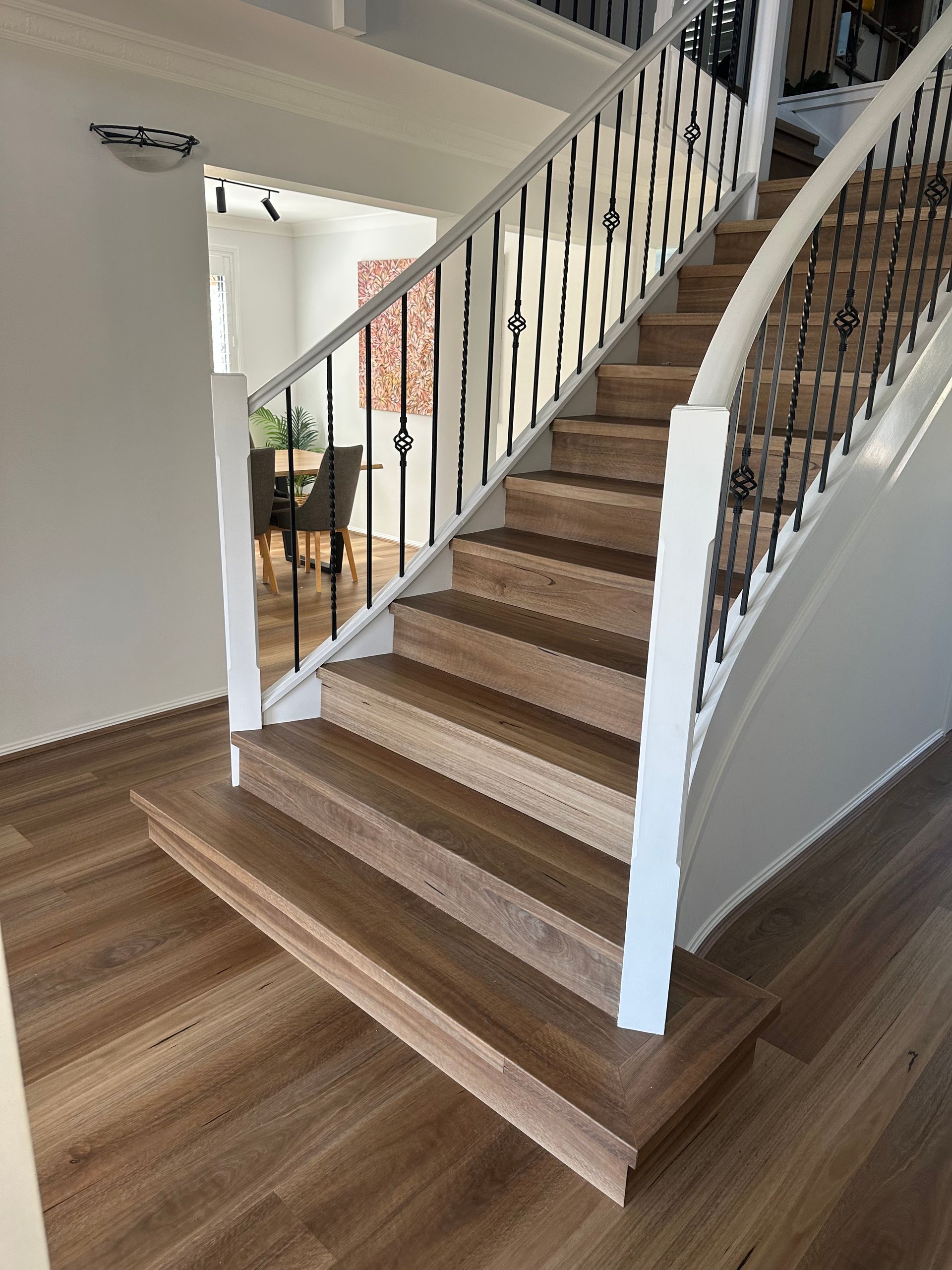 A wooden staircase with a white railing