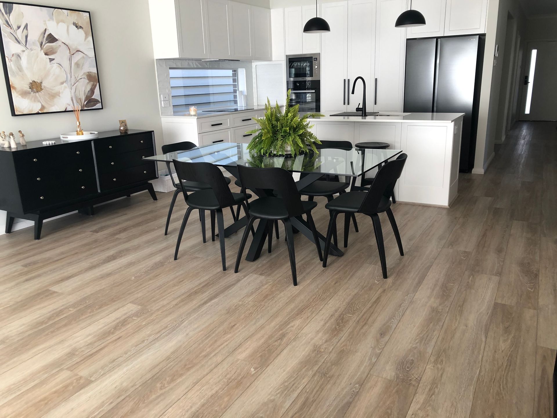 A living room with a couch , chair , table and rug.