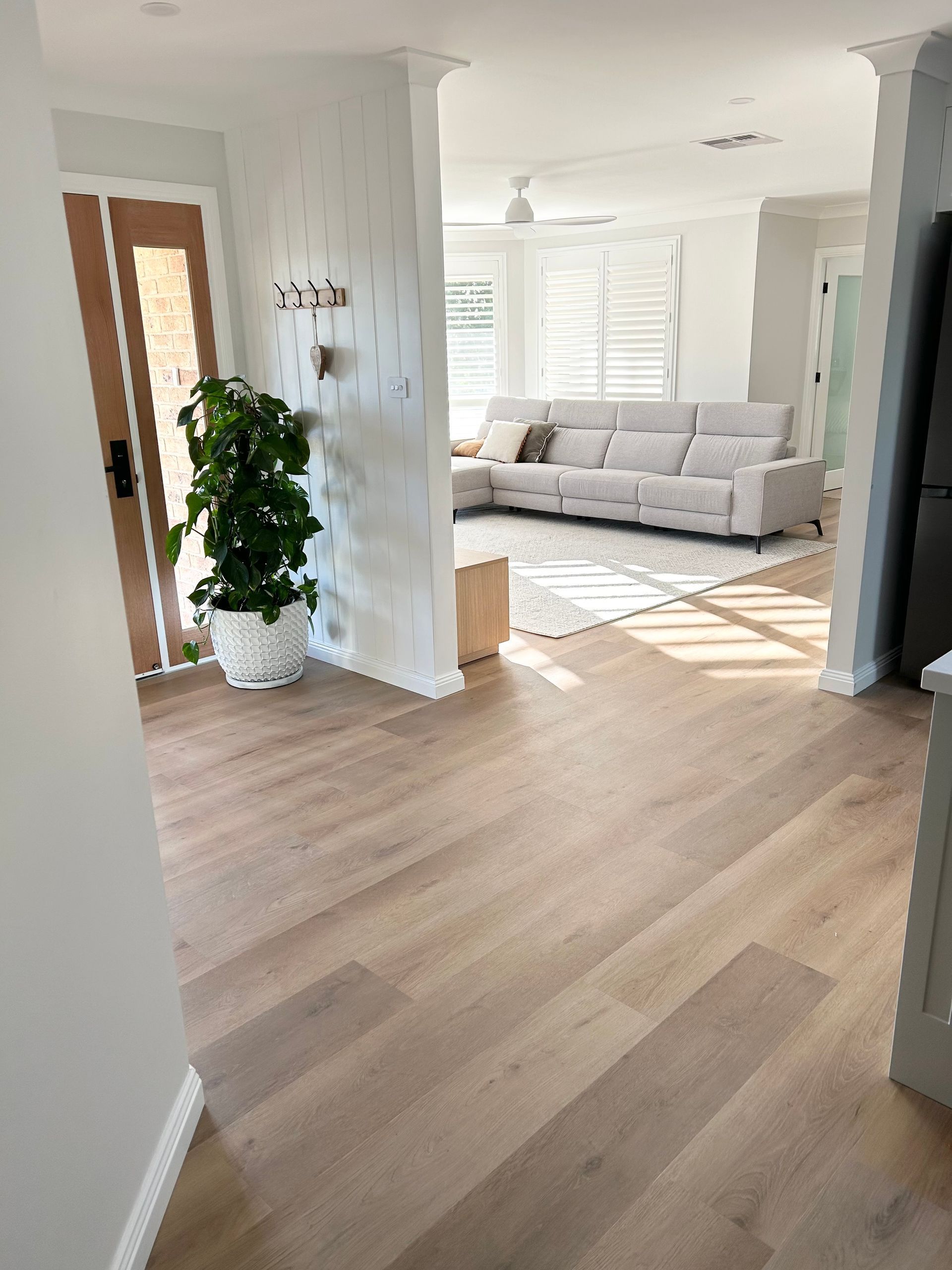 A living room with hardwood floors and a couch.