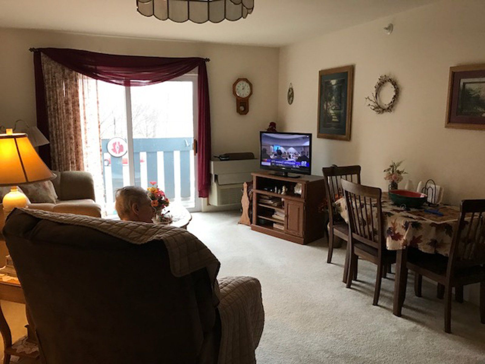 living room with sliding glass door to second level deck