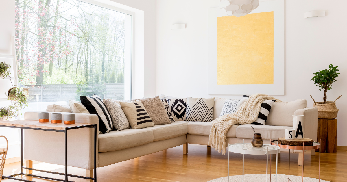 A living room with a couch , table , and a large window.