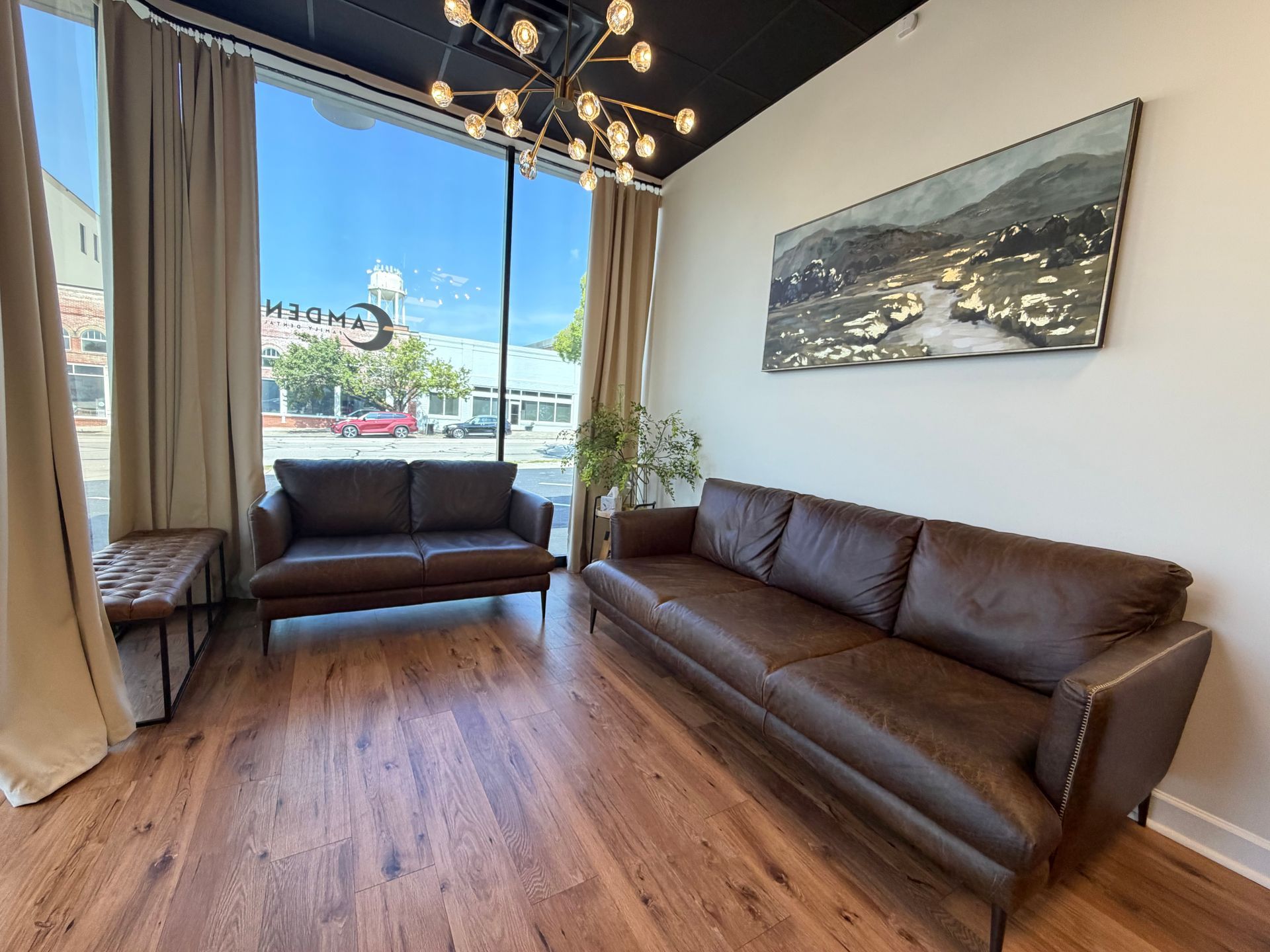 A waiting room with a lot of chairs and a large window.