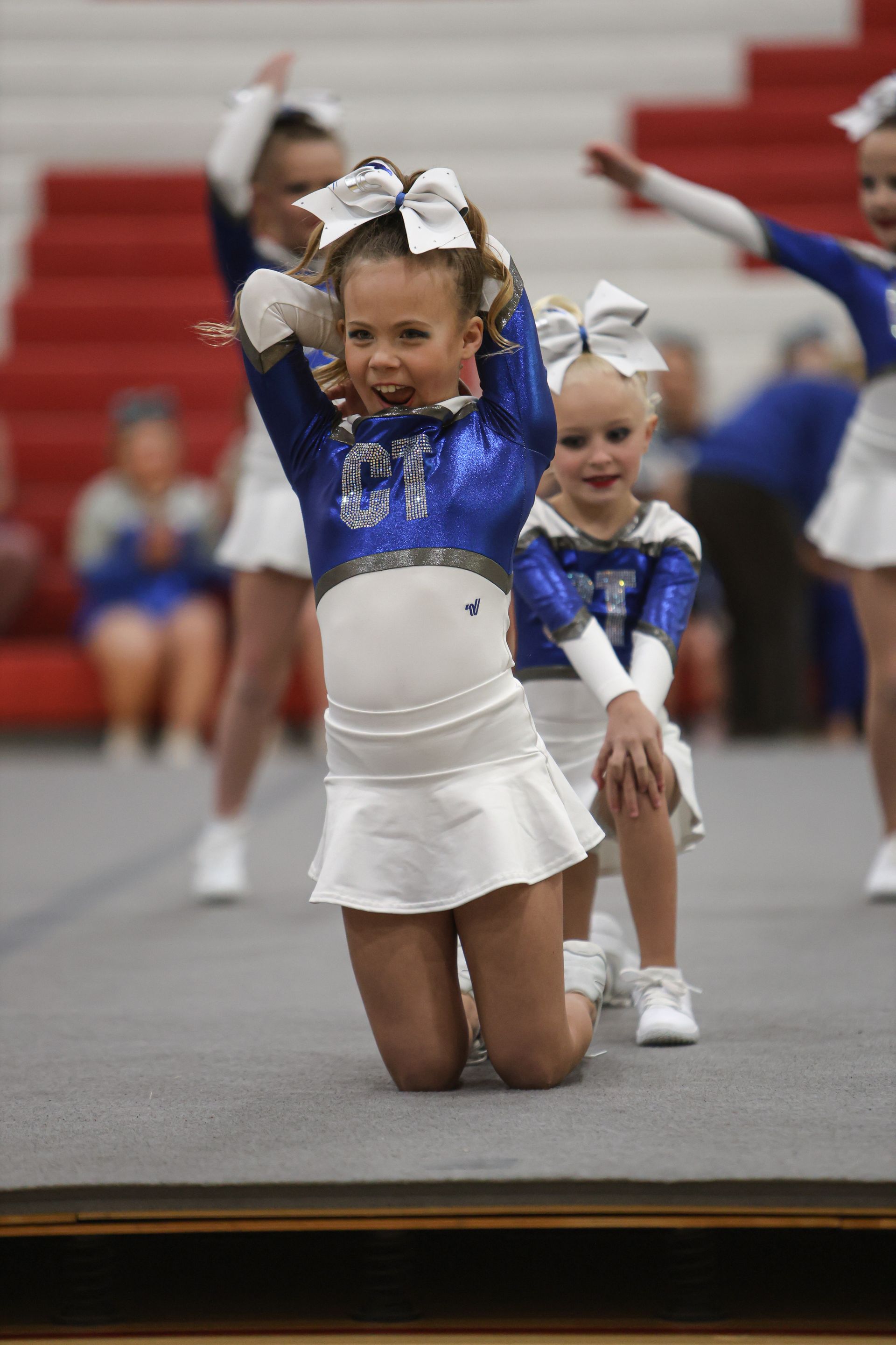 A group of cheerleaders are performing on a stage.