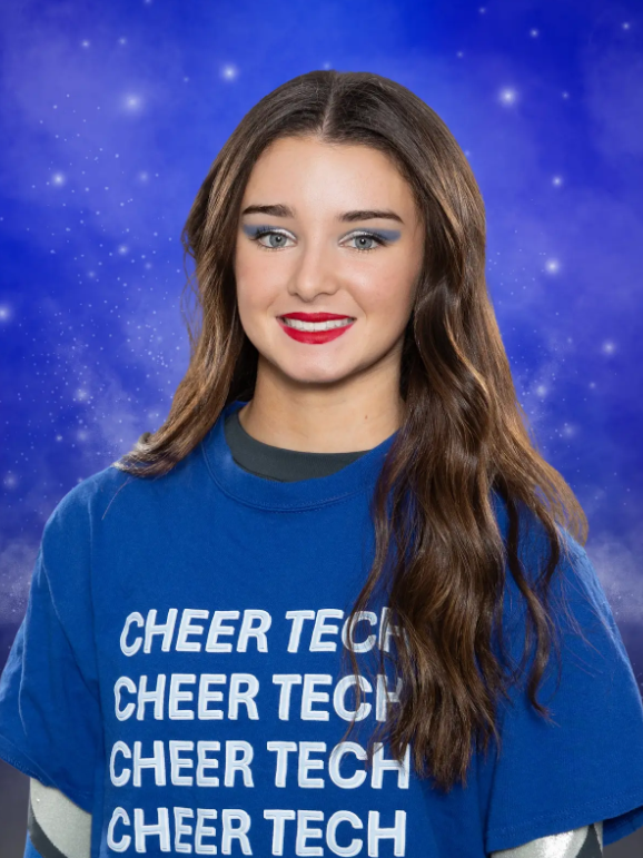 A girl wearing a blue shirt that says cheer tech