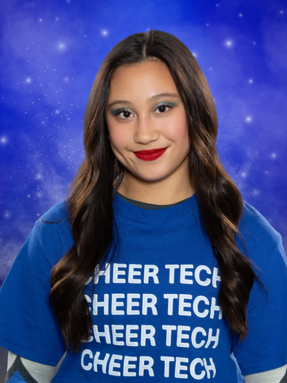 A girl wearing a blue shirt that says cheer tech