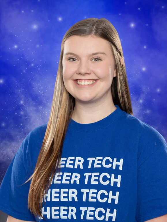 A woman wearing a blue shirt that says heer tech
