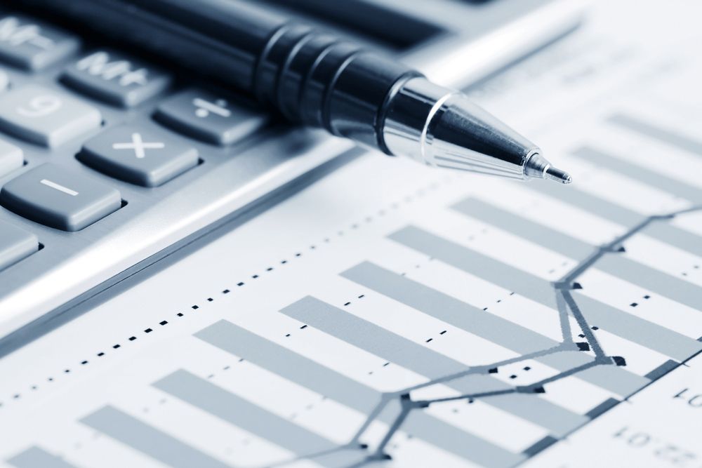 A Pen Rests on Top of A Calculator Next to A Graph — Adding Value CFO Pty Ltd in Darwin, NT