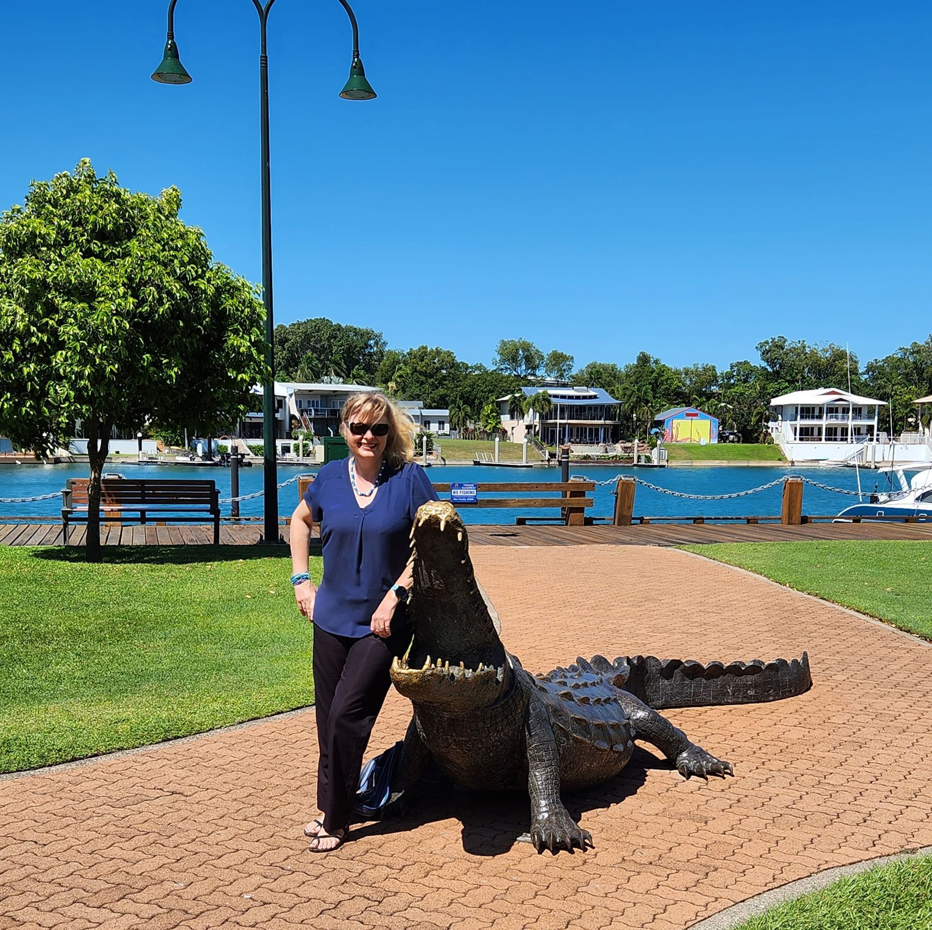 A Lady Is Standing Next to a Statue of A Croc — Adding Value CFO Pty Ltd in Larrakeyah, NT