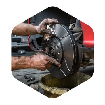 A mechanic working on a car brakes | Downtown Automotive