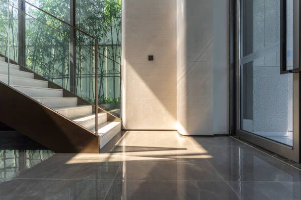 The sun shines on stairs inside a home.