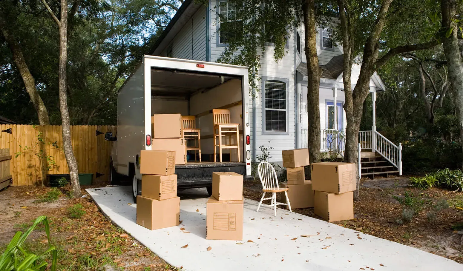 A local moving company truck parked in a neighborhood, ready for a residential move.