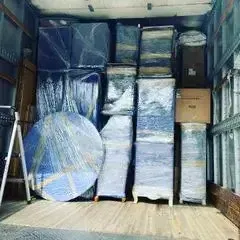 Two King Affordable Movers' crew standing together with their packed things