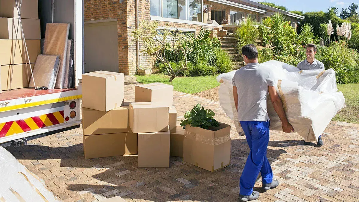  A moving crew setting up office furniture in a new commercial space, ensuring an efficient relocation.