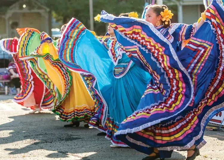 People celebrating at the Dominican Parade in Lawrence, MA, showcasing cultural diversity.