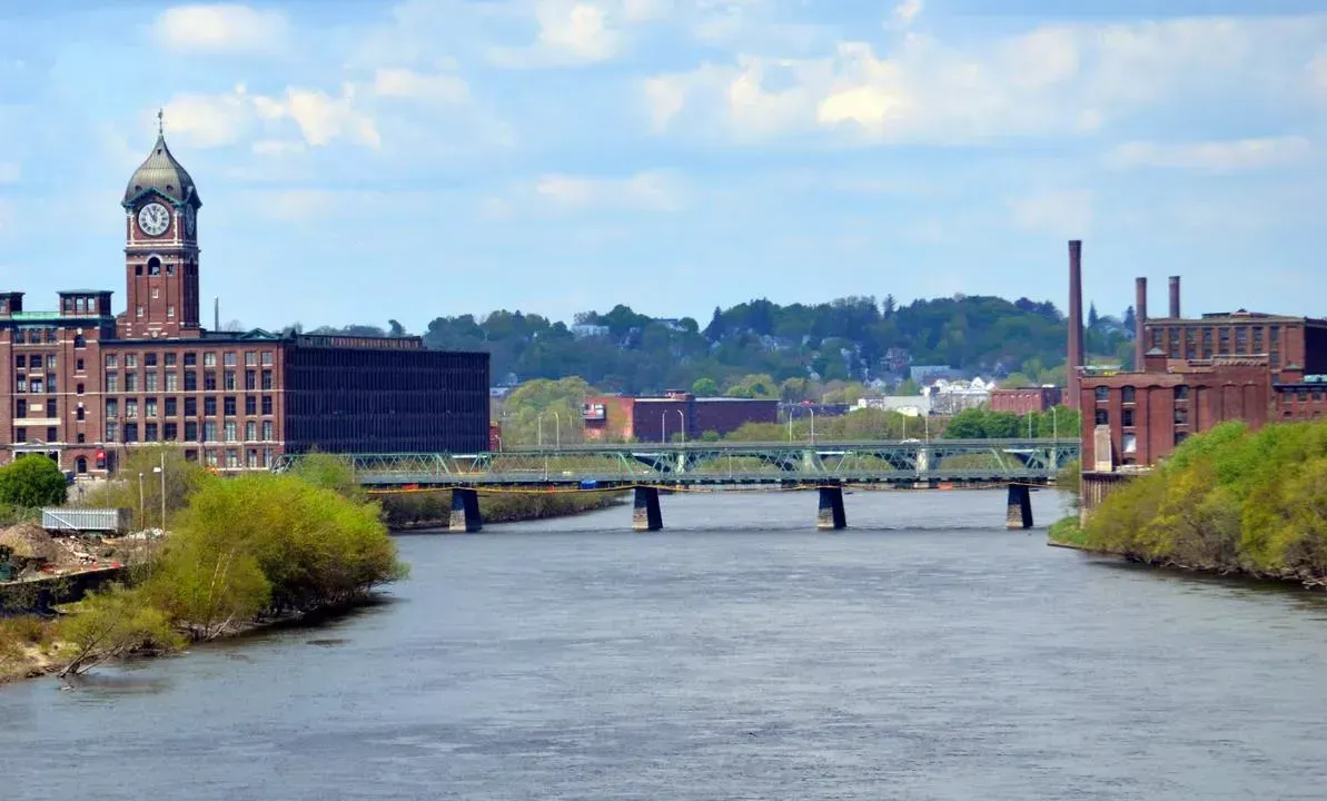 Aerial view of Lawrence, MA, showcasing the Merrimack River and historic buildings.