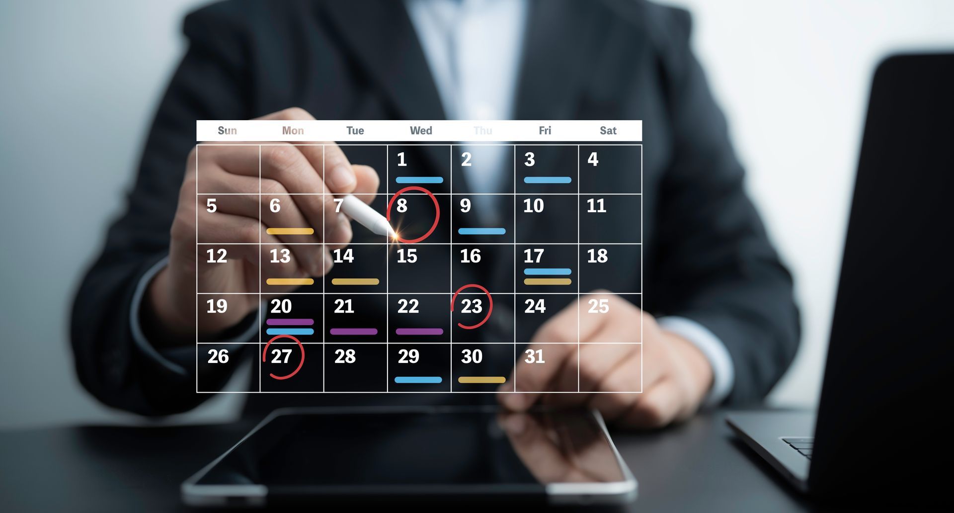 A man in a suit is looking at a calendar on a tablet.