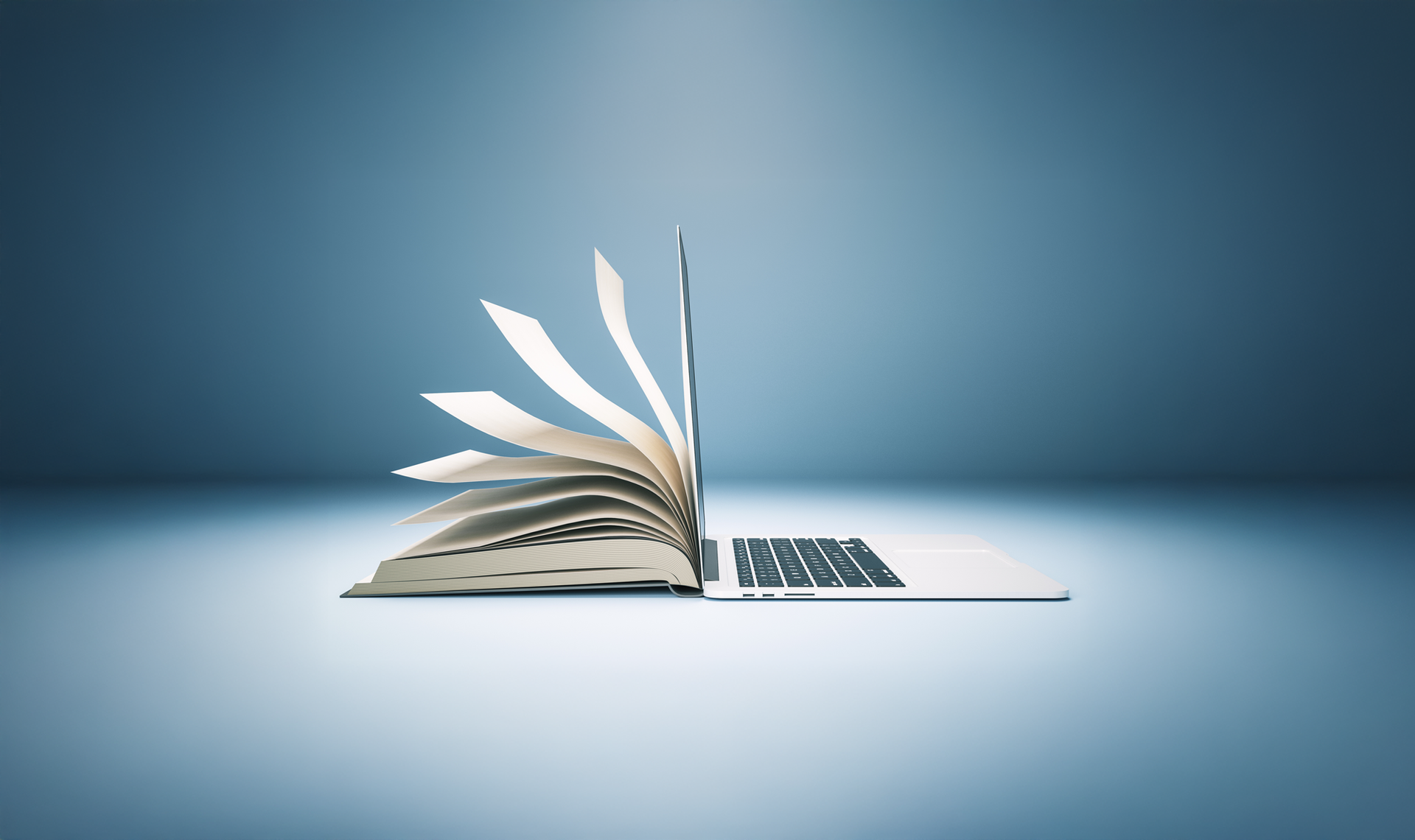 A laptop computer is sitting on top of an open book.