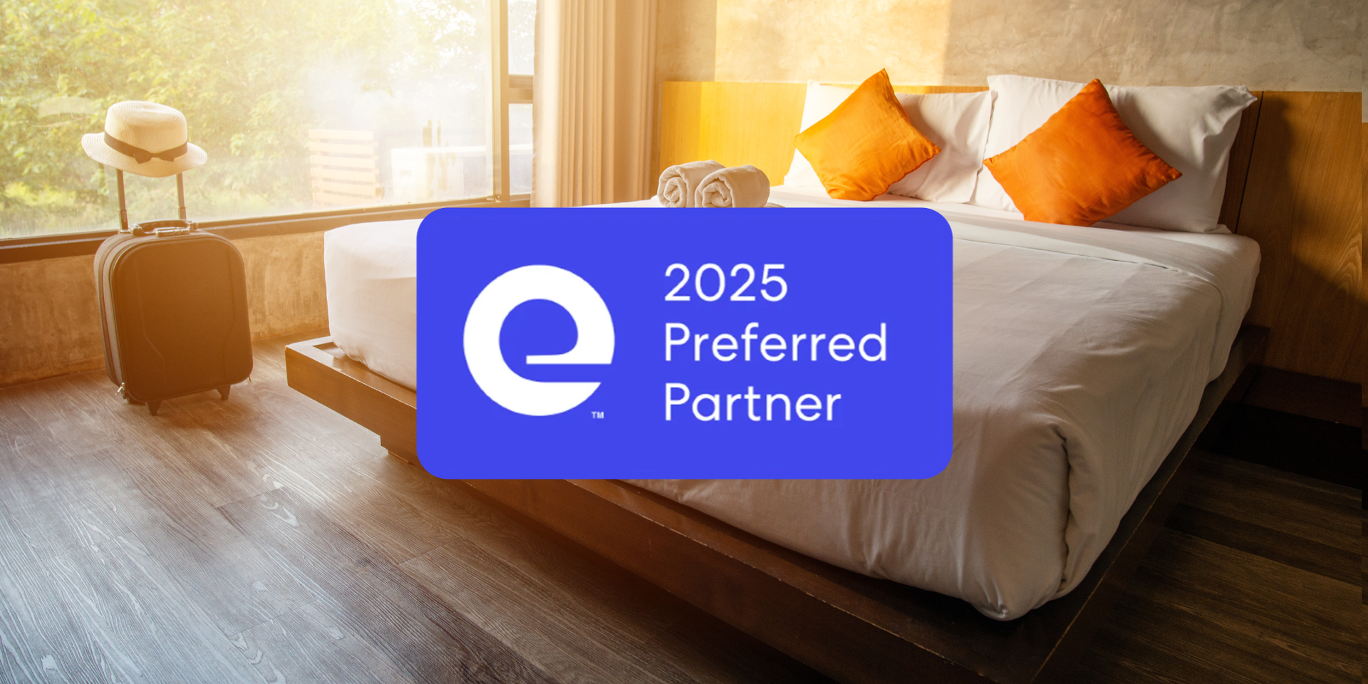 A hotel room with a bed , luggage and a sign that says `` 2025 preferred partner ''.