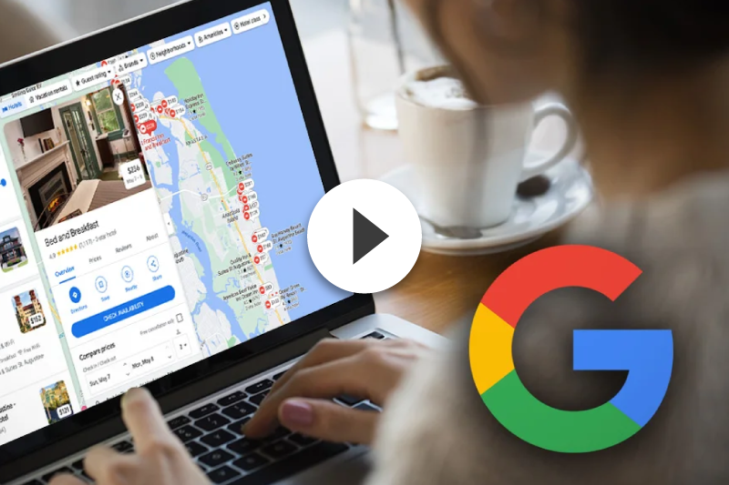 A person is using a laptop computer with a google logo in the foreground.