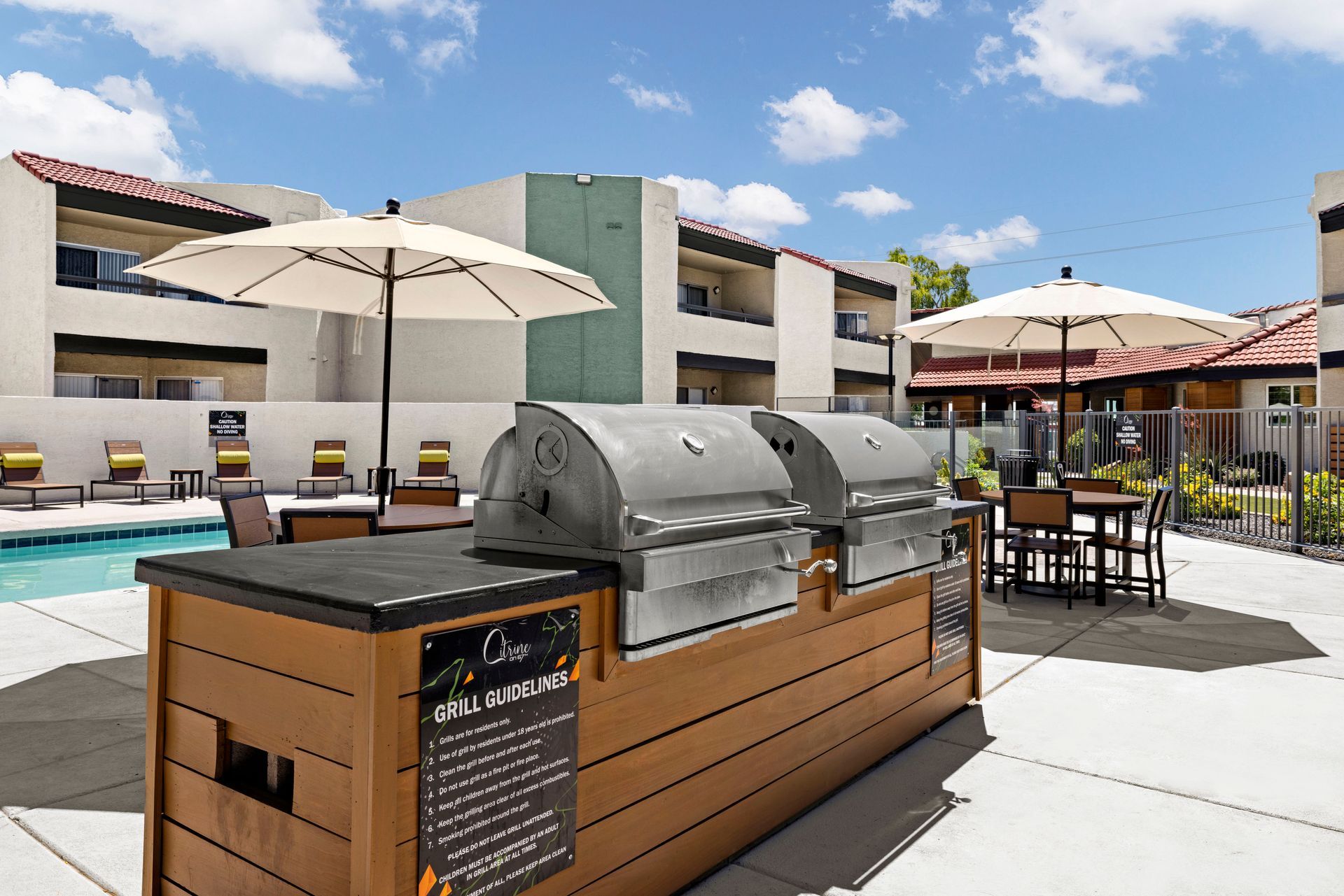 A grill is sitting next to a swimming pool at Citrine on 67th.