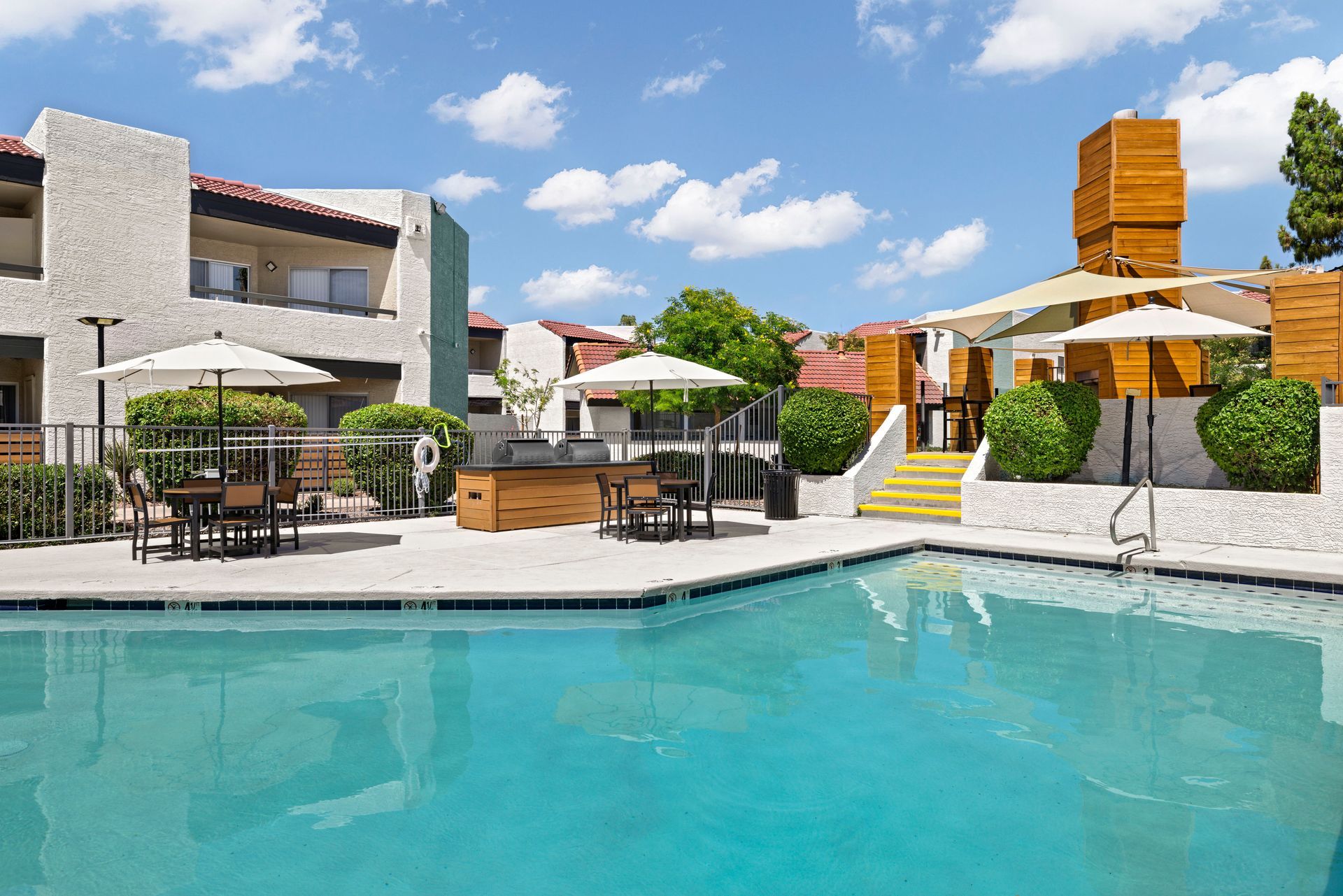 A large swimming pool in front of a building at Citrine on 67th.