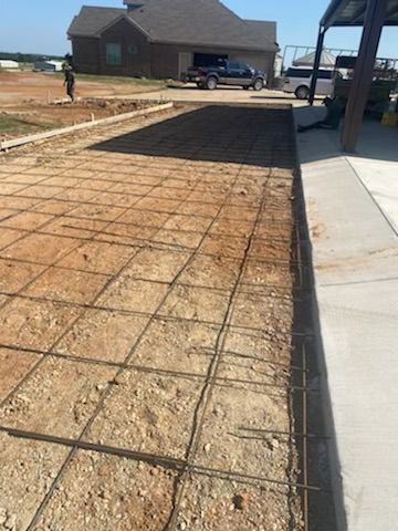 A concrete driveway is being built in front of a house.