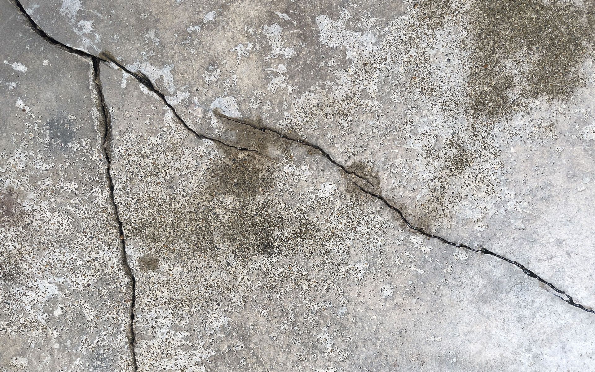 A close up of a cracked concrete floor.